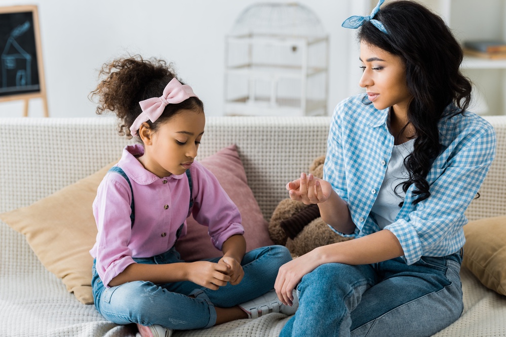 Black mother talking to her daughter