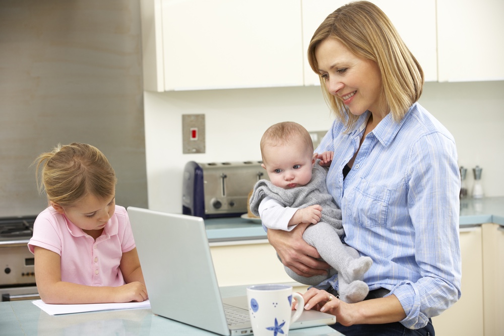 Multitasking mom working from home with children 