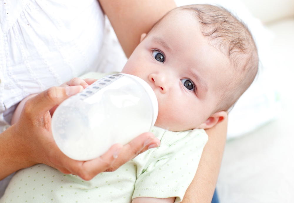 Mom bottle feeding son