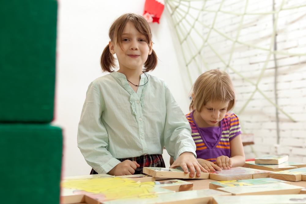 Girls working on puzzle.