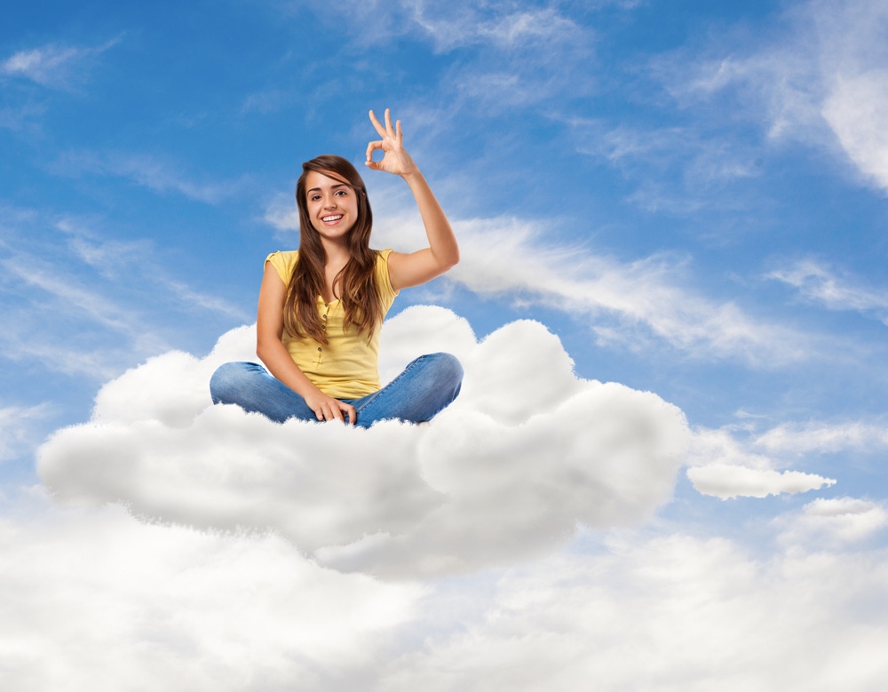 Woman sitting floating on a cloud